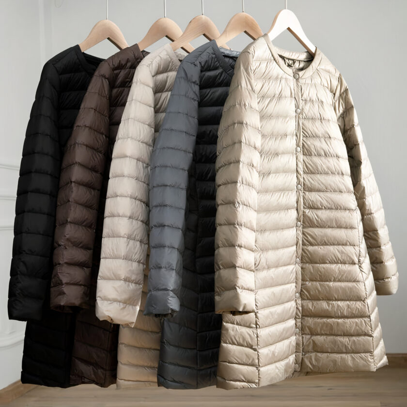 5 piumini leggeri e lunghi nei colori bianco, grigio, nero e marrone appesi alle grucce